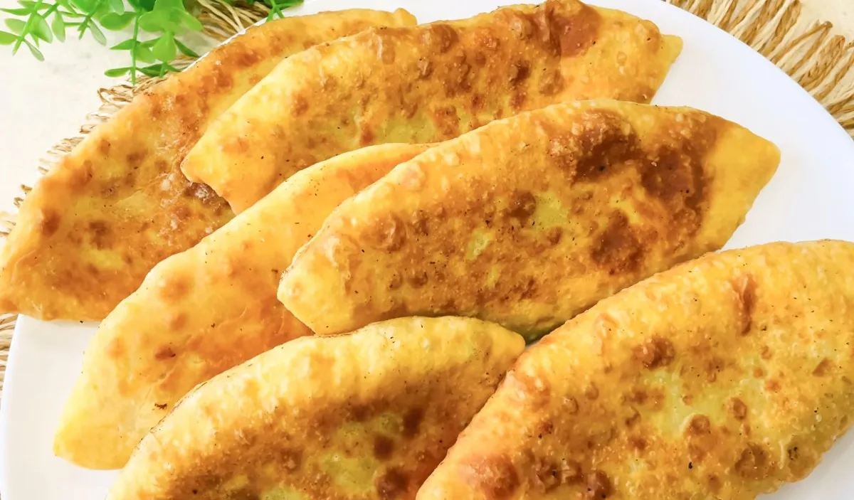 Золотистые продолговатые пирожки с мясом, обжаренные в масле