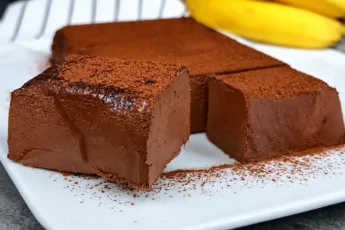 Плотный шоколадный ПП-десерт квадратной формы, нарезанный на аккуратные кубики на пергаменте
